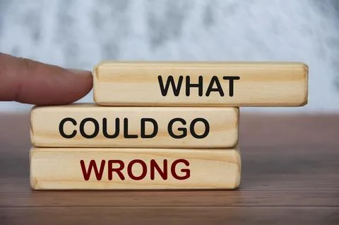 What could go wrong text on wooden blocks with blurred marble background. F.. Stock Photos