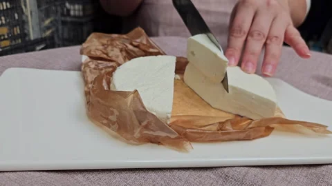 What is the difference between feta and feta cheese Close-up of Cutting or Stock Footage 277199791