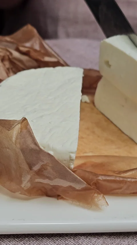 What is the difference between feta and feta cheese Close-up of Cutting or Stock Footage 277410049