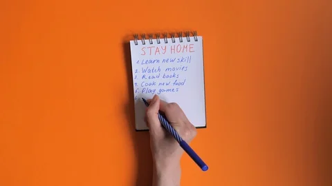 What to do at home check list written on the notepad on the orange background. Stock Footage 128077321