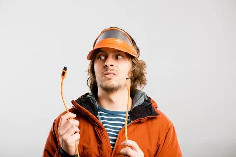 What do I do with this. a handsome young electrician standing alone in the Stock Photos