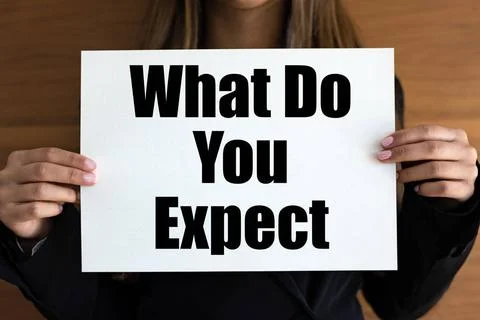 What do you expect? What do you expect? Woman with white page, black lette... Stock Photos