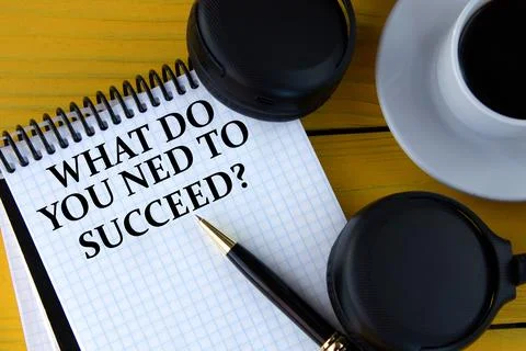 WHAT DO YOU NED TO SUCCEED? - words on a white notepad on a yellow background Stock Photos