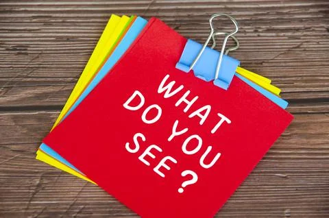 What do you see text on red notepad with wooden desk background Stock Photos