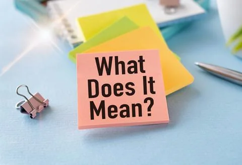 What Does It Means text on a card on a wooden background next to a pen, cal.. Stock Photos