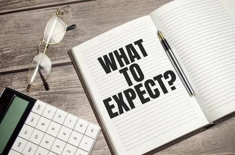 WHAT TO EXPECT text, written on a notebook with calculator, pen on the wooden Stock Photos