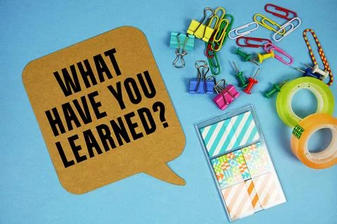 What Have you Learned? text with stationery on blue background Stock Photos