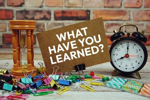 What have you Learned? text on paper card with alarm clock and stationary o.. Stock Photos