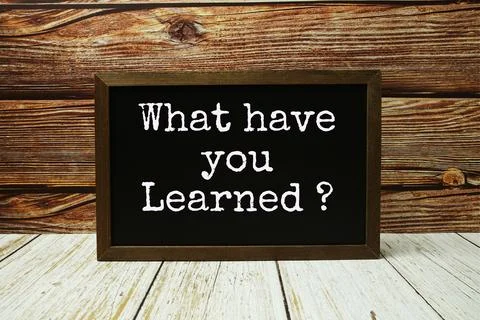 What have you Learned? text with blackboard on wooden background Stock Photos