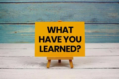 What Have You Learned? text written on paper card on wooden background Stock Photos