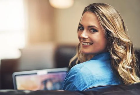 This is what I do when I have time alone. a relaxed young woman using a laptop Stock Photos