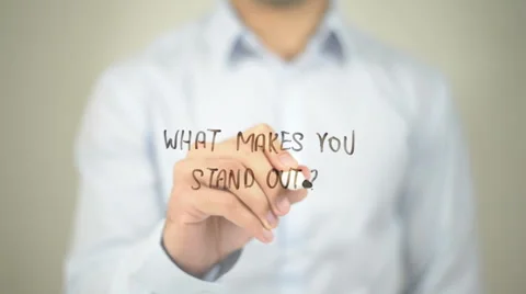 What Makes You Stand Out, man writing on transparent screen Stock Footage 62889057