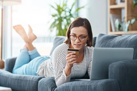 What is a paying queue again. Full length shot of a young woman using her laptop Stock Photos