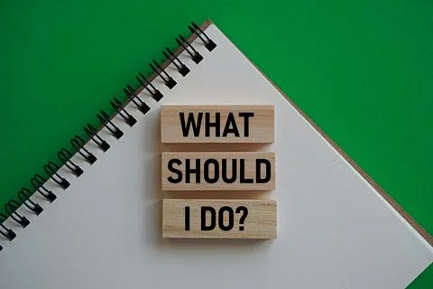 WHAT SHOULD I DO printed wood block. Self-inspiration shapes personality Stock Photos