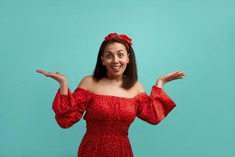 Whats the difference now. Happy unaware Caucasian woman spreads palms shrugs  Stock Photos