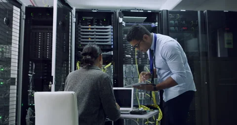 Whats the next step. 4k video footage of two technicians working together in a Stock Footage 201054707