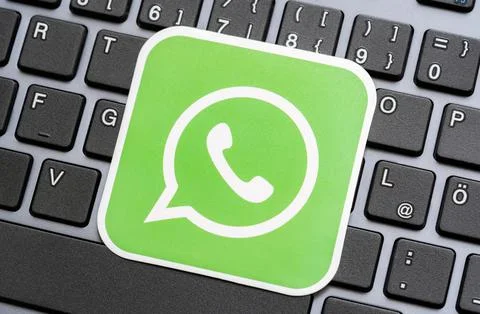 WhatsApp online communicator, messaging app green logo symbol, closeup detail Stock Photos