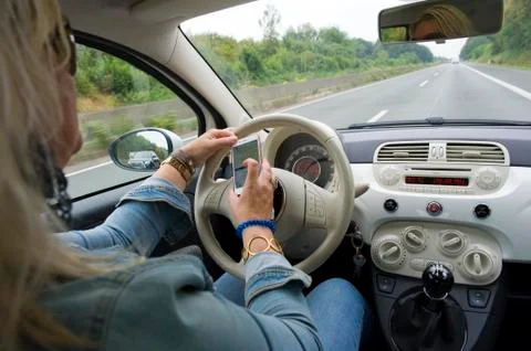 Whatsapp while driving Stock Photos