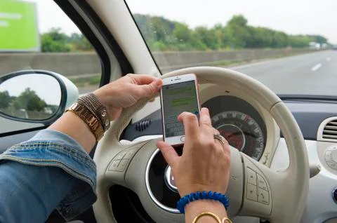 Whatsapp while driving Stock Photos