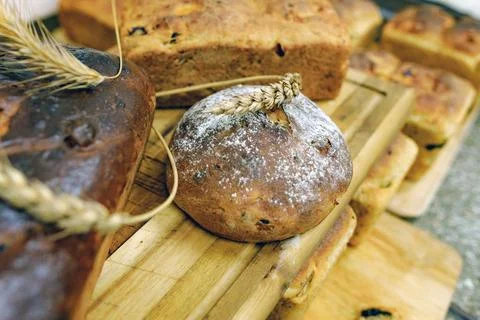 Wheat bread and rag bread on wooden boards. Decorated with ears of wheat Stock Photos