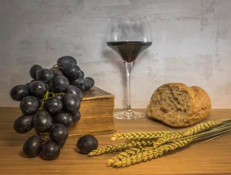 A wheat bread and red grapes with wine Stock Photos