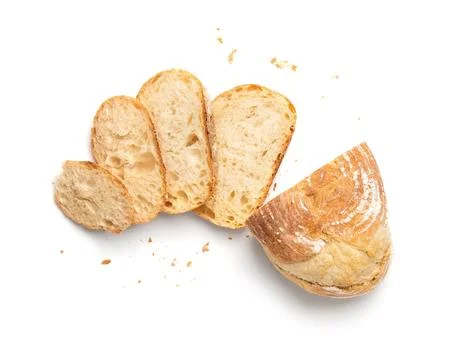 Wheat bread and slices of bread on a white background top view. Stock Photos