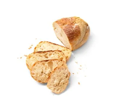 Wheat bread and slices of bread on a white background top view. Stock Photos