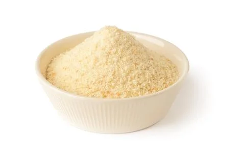 Wheat bread crumbs in a beige ceramic bowl isolated on white background. Stock Photos