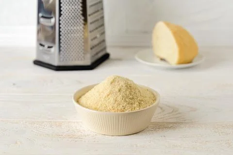 Wheat bread crumbs in a beige ceramic bowl on a kitchen table. Stock Photos