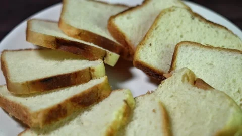 Wheat bread slice rotates on a white plate. Stock Footage 323967352
