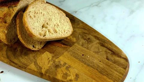 Wheat bread slices on a  cutting board Stock Photos
