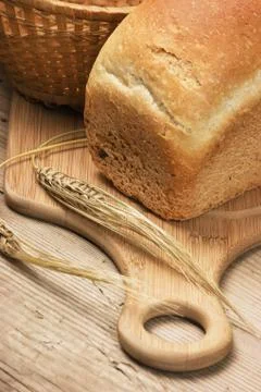 Wheat bread on a wooden table Stock Photos