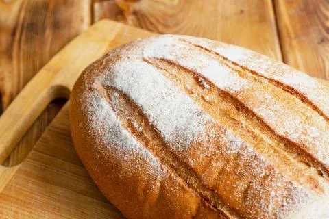 Wheat bread on a wooden table Stock Photos