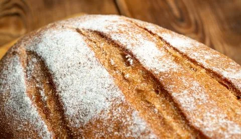 Wheat bread on a wooden table Stock Photos
