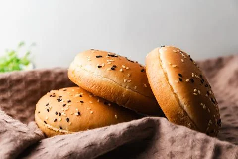 Wheat burger buns on the kitchen table Stock Photos