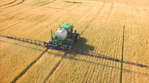 Wheat field being sprayed Vídeos de archivo 66805116