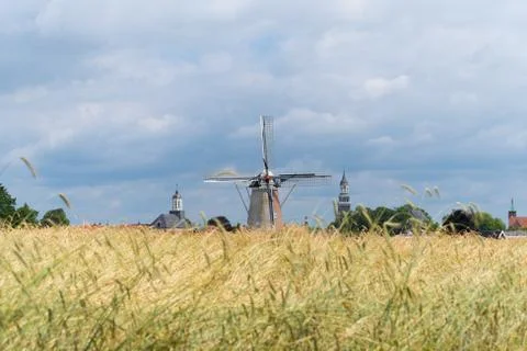 Wheat field with windmill Stock Photos