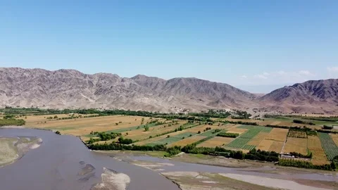 Wheat Fields Flourish by the Kunar River Stock Footage 274868603