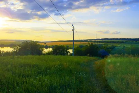 Wheat fields by the lake at sunset of the day. Stock Photos