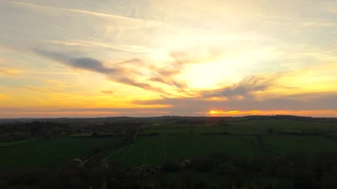 Wheat fields wide rural landscape under dramatic sunset sky with clouds and low Stock Footage 333580279