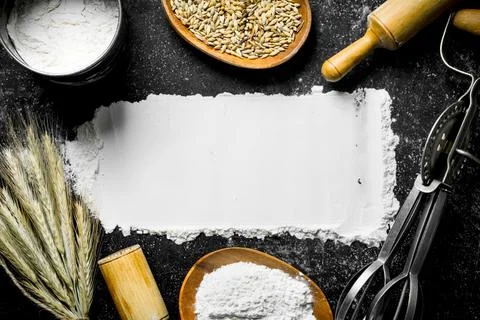 Wheat flour with grain, spikelets, rolling pin and mixer. Stock Photos