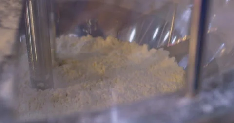 Wheat flour is mixed inside an industrial mixer. Close-up Stock Footage 318317438