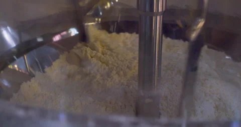 Wheat flour is mixed inside an industrial mixer. Close-up Stock Footage 318317784