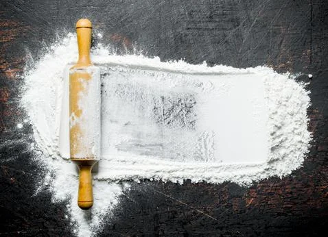 Wheat flour with rolling pin. Stock Photos