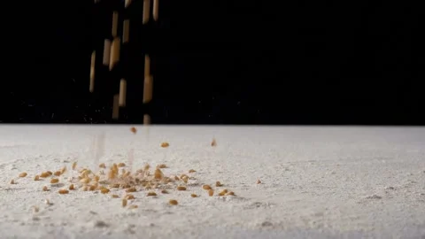 Wheat grains falling on a surface layered with flour -  Indian agriculture pr... Video stock 223996797