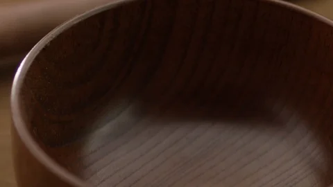 Wheat grains falling in a wooden cup close-up on a black background Video stock 85836853