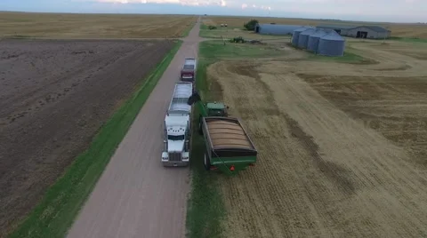 Wheat Harvest John Deere Grain Cart and Semi Truck - Drone Stock Footage 65028797