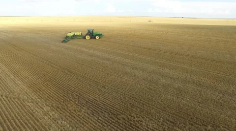 Wheat Harvest John Deere Tractor Medium Shot - Drone Stock Footage 65028904