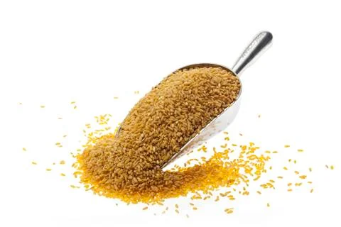 Wheat in silver tin scale spoon on white background. food Stock Photos