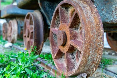 Wheel of an abandoned rusty mining wagon. Concept old style, vintage, rust metal Stock Photos